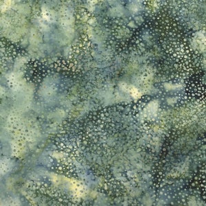 May include: Textile with a mottled pattern in shades of blue, green, and yellow. The fabric has a speckled appearance, with small, irregular white dots scattered across the surface. The overall effect is reminiscent of a watercolor painting or a natural landscape.