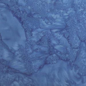 May include: A blue fabric with a marbled pattern. The fabric has a light blue background with darker blue swirls and streaks.