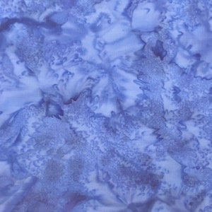 May include: A blue and white abstract fabric with a tie-dye pattern. The fabric has a soft, flowing texture and a subtle sheen.