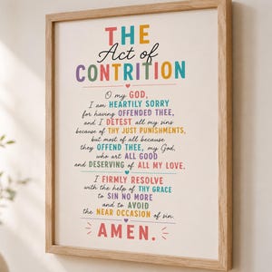 May include: A framed wall print featuring the text The Act of Contrition in a colourful, multi-font design. The prayer is printed in various shades of red, blue, yellow, and purple against a white background, enclosed in a light wood frame.