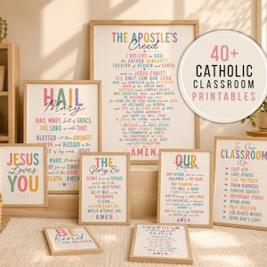 May include: A collection of framed Catholic prayer and classroom rule posters featuring colorful typography. The prints include The Apostle's Creed, Hail Mary, The Glory Be, Our Father, and Jesus Loves You, with a circular badge stating 40+ Catholic Classroom Printables.