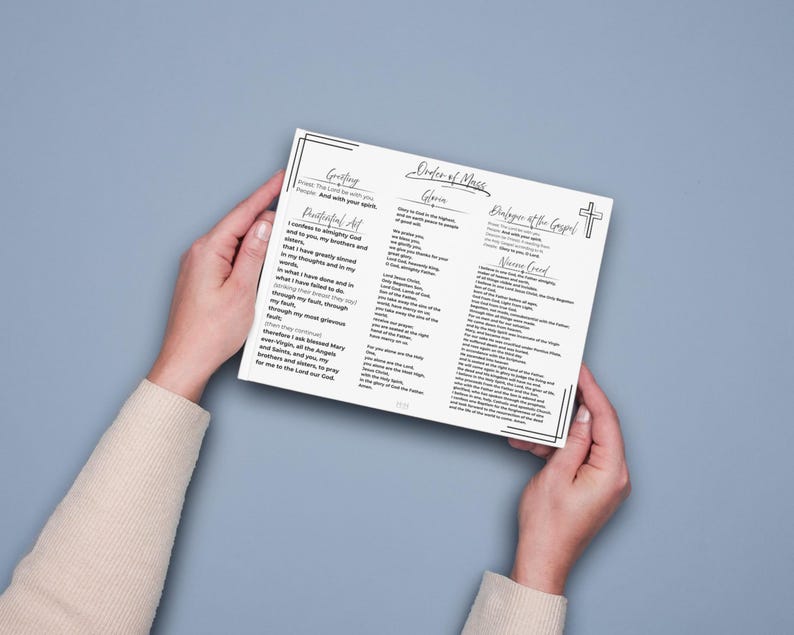 May include: A white printed card featuring the Order of Mass with black text and a cross icon. The document includes sections titled Greeting, Penitential Act, Gloria, Dialogue at the Gospel, and Nicene Creed, all framed by a thin black border.