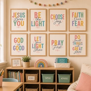 May include: A set of eight rectangular wall art prints in light wood frames, each featuring colourful inspirational text including Jesus Loves You, Be the Light, Choose Joy, Faith Over Fear, God is Good, Let Your Light Shine, Pray First, and Do Small Things.