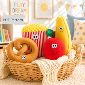 May include: A woven basket filled with plush food toys, including a pretzel, popcorn, apple, and banana. The popcorn is in a red and white striped container. Each toy has a smiling face. The text "PDF Pattern" is in the upper left corner.