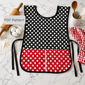 May include: A black and red polka dot apron with the text "PDF Pattern". The apron has a black trim and ties. The top portion is black with white polka dots, and the bottom is red with white polka dots. The apron is designed for kitchen use.
