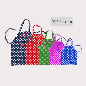 May include: Five colourful polka dot aprons in navy, red, green, pink, and blue. Each apron features white polka dots and matching neck straps and ties. The text "PDF Pattern" is displayed in a grey rectangle.