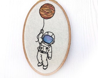Little Astronaut hanging on to a planet Finished water color hand embroidery wall art medium size