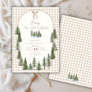 May include: A winter-themed baby shower invitation. The design includes a watercolor illustration of pine trees and the phrase "Baby, it's cold outside." The background has a beige and white gingham pattern. The date and time are also displayed.