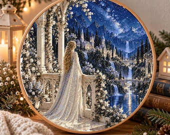 May include: A circular embroidery hoop containing a detailed fabric print of a long-haired figure in a white gown standing on a stone balcony overlooking a waterfall, a castle, and a starry night sky with blue and white tones.