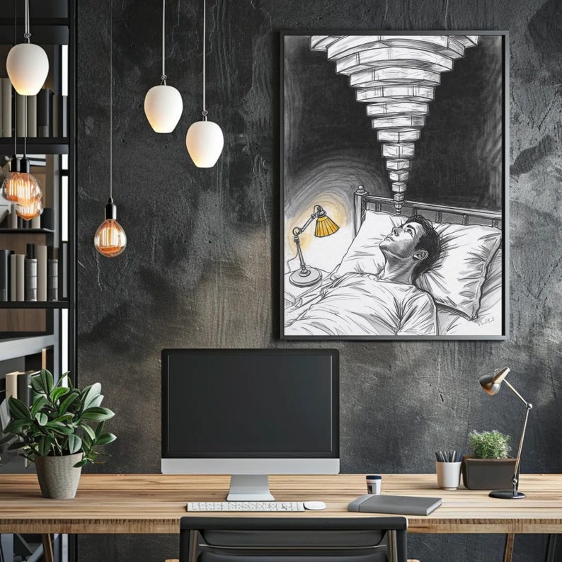 Framed insomnia and anxiety art print on a dark concrete wall above a wooden office desk, black and white sketch shows a person awake in bed with a yellow bedside lamp and stacked ceiling lights