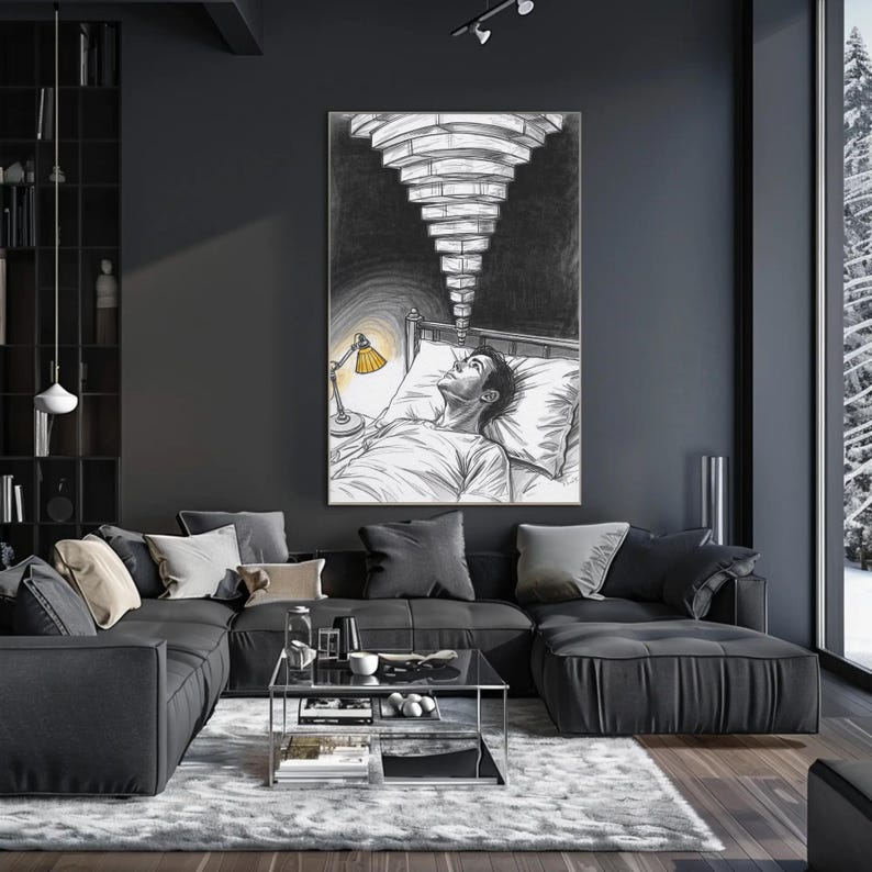 Framed overthinking insomnia wall art above a dark sectional sofa in a moody modern living room, artwork shows a person lying awake in bed with a yellow bedside lamp