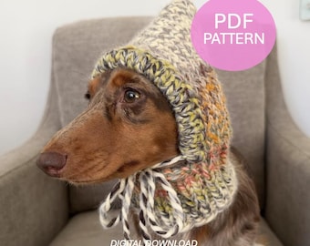 May include: A brown dachshund wearing a chunky knit bonnet with a variegated yarn pattern in shades of green, yellow, and grey. The bonnet features a pointed top and braided ties under the chin. The image includes the text PDF PATTERN and DIGITAL DOWNLOAD.