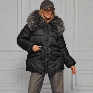 This premium winter collection features water-repellent polyester coats designed for extreme cold. Models include a quilted maxi jacket rated for -15°C with silicone 200 and bio-down puffers handling temperatures down to -20°C. Features include non-removable hoods, detachable fur, and adjustable drawstrings for a custom silhouette. Functional pockets and zip-and-button closures ensure a cozy winter outlook. Stay warm! ❄️🧥