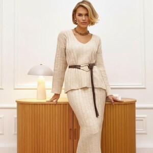 💎 Relaxed women pullover with a sophisticated v neck collar and dropped shoulders for a modern, "free-style" silhouette.
💎 Coordinating womens midi skirt in a maxi length, featuring a flexible elastic waist for all-day comfort.
💎 A chic knitted costume that offers the refined look of a crochet top dress with the practical warmth of a knitwear suit.
💎 Versatile knit women set that easily transitions from casual loungewear to a polished city outfit.
