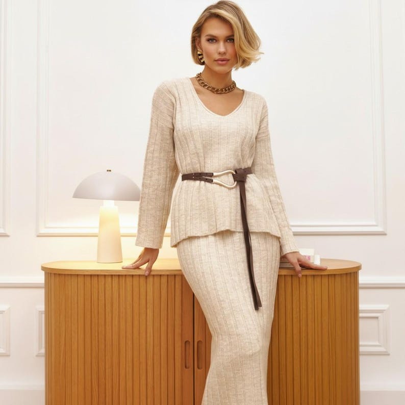 💎 Relaxed women pullover with a sophisticated v neck collar and dropped shoulders for a modern, "free-style" silhouette.
💎 Coordinating womens midi skirt in a maxi length, featuring a flexible elastic waist for all-day comfort.
💎 A chic knitted costume that offers the refined look of a crochet top dress with the practical warmth of a knitwear suit.
💎 Versatile knit women set that easily transitions from casual loungewear to a polished city outfit.