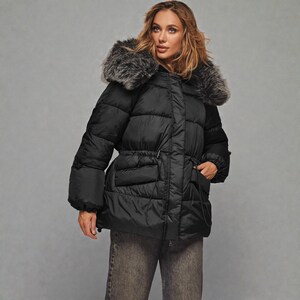 This premium winter collection features water-repellent polyester coats designed for extreme cold. Models include a quilted maxi jacket rated for -15°C with silicone 200 and bio-down puffers handling temperatures down to -20°C. Features include non-removable hoods, detachable fur, and adjustable drawstrings for a custom silhouette. Functional pockets and zip-and-button closures ensure a cozy winter outlook. Stay warm! ❄️🧥