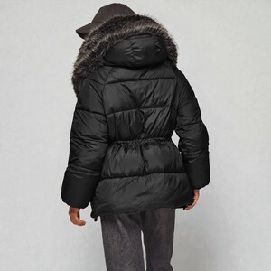 This premium winter collection features water-repellent polyester coats designed for extreme cold. Models include a quilted maxi jacket rated for -15°C with silicone 200 and bio-down puffers handling temperatures down to -20°C. Features include non-removable hoods, detachable fur, and adjustable drawstrings for a custom silhouette. Functional pockets and zip-and-button closures ensure a cozy winter outlook. Stay warm! ❄️🧥