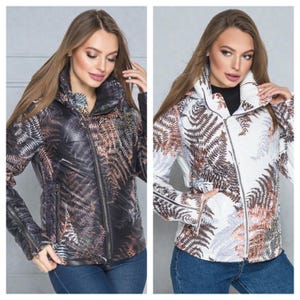 This white puffer jacket blends high-fashion botanical prints with functional design, keeping you comfortable in temperatures down to -5C.

Top Performance Specs
❄️ Insulation: Premium Biosilicone 120 mm for a light down jacket feel.
❄️ Weatherproof: Durable, waterproof raincoat fabric (100% polyester).
❄️ Closure: Unique voluminous diagonal zip puffer coat.
❄️ Collar: High stand-up style for wind protection.
❄️ Utility: Convenient slit pockets and decorative sleeve zippers.