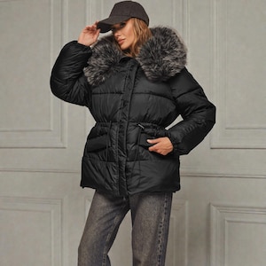 This premium winter collection features water-repellent polyester coats designed for extreme cold. Models include a quilted maxi jacket rated for -15°C with silicone 200 and bio-down puffers handling temperatures down to -20°C. Features include non-removable hoods, detachable fur, and adjustable drawstrings for a custom silhouette. Functional pockets and zip-and-button closures ensure a cozy winter outlook. Stay warm! ❄️🧥