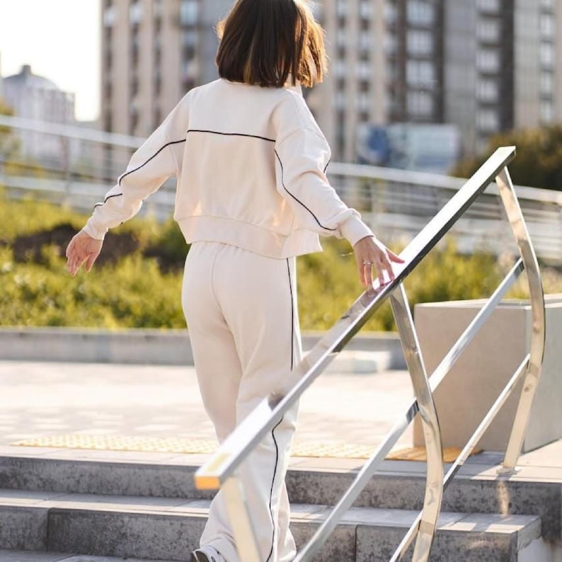 💫Effortless Style with Our Women's Two-Piece Set of Hoodie and Palazzo! 💫

✨Fabric - Peyne (3-thread loop)
90% Сotton, 10% polyester

Set includes: Hoodie and Palazzo pants

Step into the ultimate comfort and style with this versatile women's tracksuit. This isn't just a basic loungewear; it's a chic streetwear women set that's perfect for both relaxed days and running errands. This beautiful two-piece women set doubles as a cozy outfit and a fashionable statement piece.