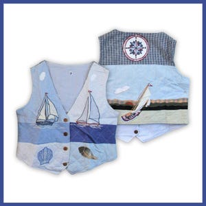 May include: Two quilted vests with nautical themes. One vest features sailboats, seashells, and blue and white patterns. The other vest has a compass rose and a sailboat scene. Both vests have button closures and are made of fabric.
