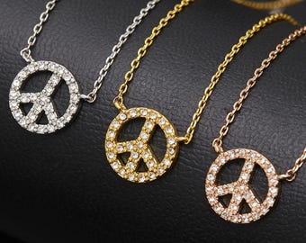 diamond peace sign pendant necklace, shown in what appears to be sterling silver, yellow gold, and rose gold finishes.
