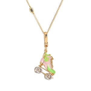 May include: Gold-tone necklace featuring a roller skate pendant. The pendant is pink and green with silver-tone wheels and a small chain. The necklace has a delicate chain and a lobster clasp.