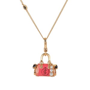 May include: Gold-tone metal necklace with a charm shaped like a pink handbag. The handbag charm has black accents, clear rhinestones, and a logo. The necklace chain is delicate and has a lobster clasp.