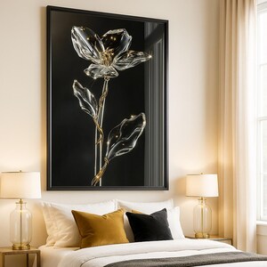 May include: A framed artwork featuring a clear glass flower with a gold stem and leaves against a black background. The flower is illuminated with small lights, creating a sparkling effect. The artwork is displayed in a bedroom setting.