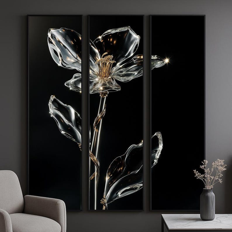 May include: A triptych artwork showing a large glass flower against a black backdrop. The flower has clear, crystalline petals and leaves, with gold accents on the stem and centre. The artwork is framed in black.