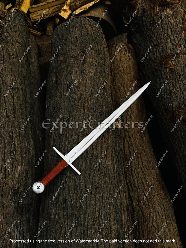 May include: A medieval sword with a silver blade and a brown leather-wrapped handle. The sword features a crossguard and a decorative pommel. The image is set against a backdrop of dark, textured wood.