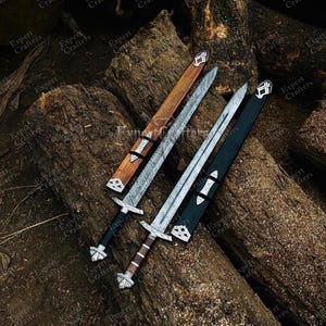 May include: Three swords with sheaths rest on a pile of logs. The swords have silver blades with intricate patterns, black and brown handles, and decorative silver crossguards. The sheaths are brown and black with silver accents. The image has the text "Expert Crafters".