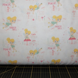 Camelot Fabrics. Peter Pan & Tinkerbell. Tinkerbell Pixie Magic White