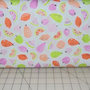 May include: White fabric with a repeating pattern of pink, orange, and green fruit. The fruit includes lemons, limes, pears, and watermelon slices.