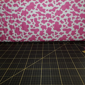 QT Fabrics. Hey Cowgirl. Cowskin Pink - this is not a bright white background. See pictures 3-4 for how it looks with other colors.