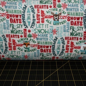 Northcott. Warmin' Up Winter. Words Cream FLANNEL