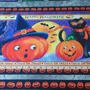 May include: A Halloween-themed fabric panel with a black cat wearing a mask and a pumpkin with a witch's hat. The panel features a full moon, bats, and the text "HAPPY HALLOWEEN".
