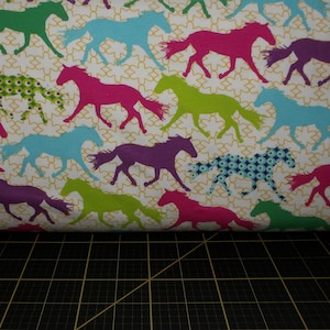 Stof France. Multicolored Horses 63 inch Wide KNIT