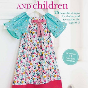 May include: A book titled "Sewing for babies and children" with a pink and blue floral dress on a hanger. The book cover features a pink bow on the dress and the text "25 beautiful designs for clothes and accessories for ages 0-5" and "Including 15 full-size patterns".