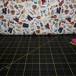 QT Fabrics. Tiny Tunes. Instrument Toss Cream - Music Instrument Fabric