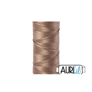 May include: A spool of brown embroidery floss, wound tightly, with the brand name "Aurifil" printed on a white label.