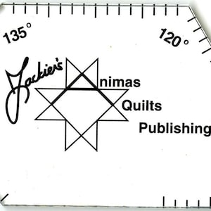 May include: A clear plastic quilting ruler with a star design and the text "Jackie's Animas Quilts Publishing" printed on it. The ruler has markings for 90, 120, 135, and 09 degrees.