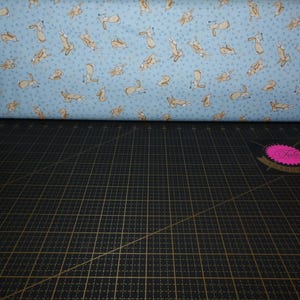 Clothworks. GHMILY 2024. Tossed Bunnies Light Denim - Guess How Much I Love You Fabric