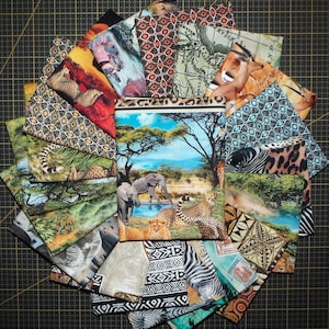 May include: A selection of fabric squares showcasing African wildlife and patterns. The designs include elephants, lions, cheetahs, and zebras, alongside map and geometric motifs. The colour scheme features browns, greens, blues, and oranges, creating a vibrant display.