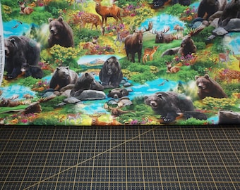 May include: A colourful fabric depicting a wilderness scene with bears, deer, and moose in a lush forest. The design includes a river, flowers, and various wildlife, creating a detailed and lively pattern, suitable for various craft projects.