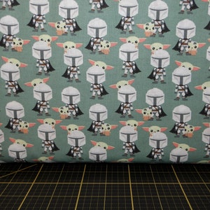 Camelot Fabrics. Star Wars Mandalorian. Mando Hello Friend Green - Grogu and Mandalorian Fabric