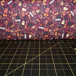 QT Fabrics. Tiny Tunes. Instrument Toss Maroon - Music Instrument Fabric