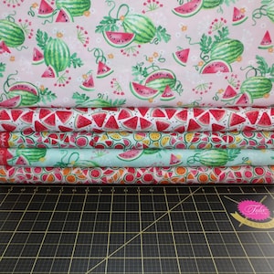 May include: Five different fabric panels with a watermelon print. The top panel is pink with green watermelon slices and whole watermelons. The next panel is white with red watermelon slices. The third panel is light blue with green watermelon slices. The fourth panel is orange with red watermelon slices. The bottom panel is white with yellow watermelon slices.