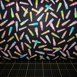 QT Fabrics. All Dolled Up. Lipstick Toss Black - Beautician and Cosmetologist fabric