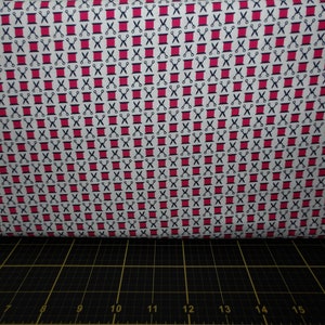 May include: White fabric with a repeating pattern of red spools of thread and black scissors. The pattern is a simple, geometric design.